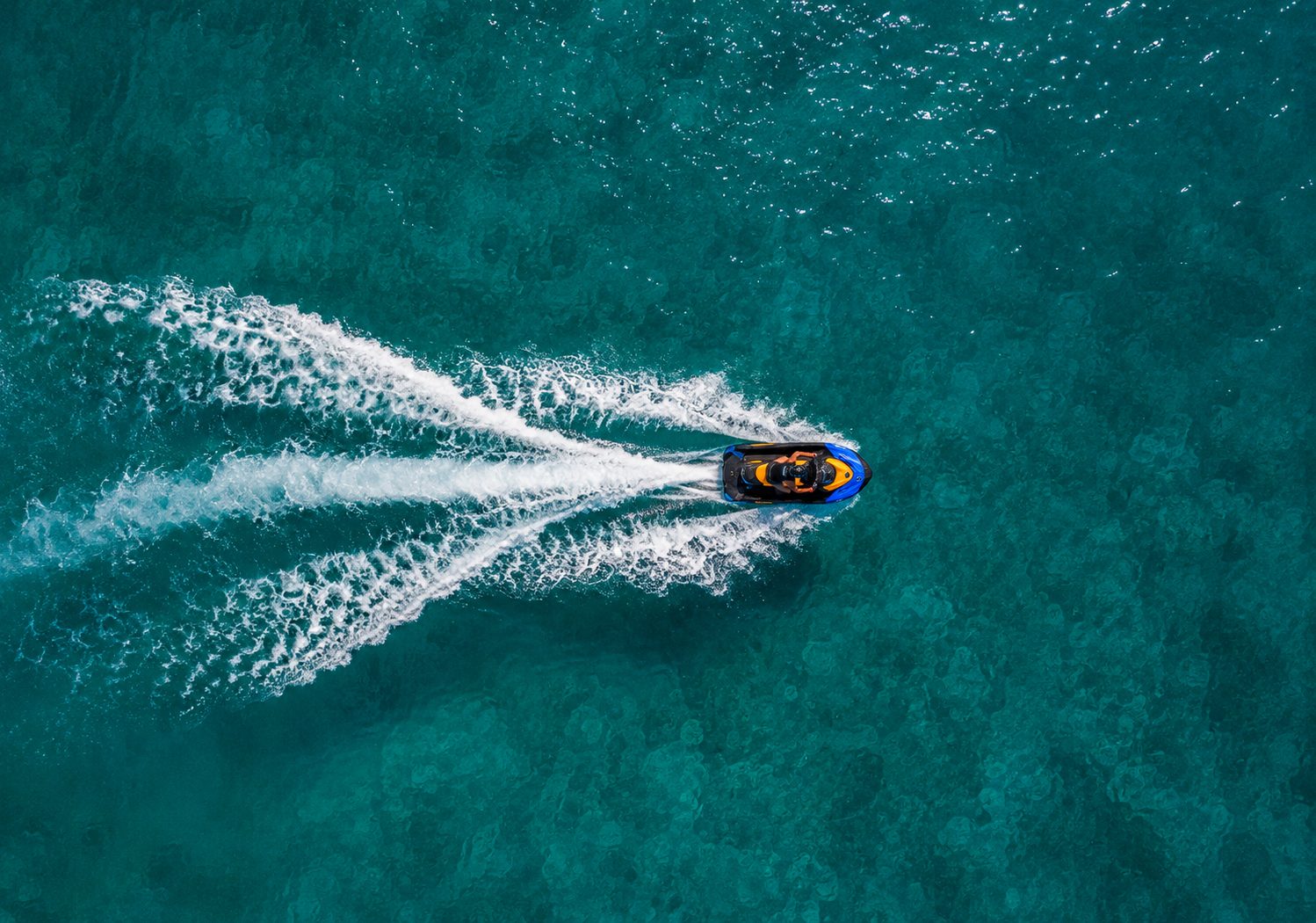 Aerial view of jet ski on turquoise water